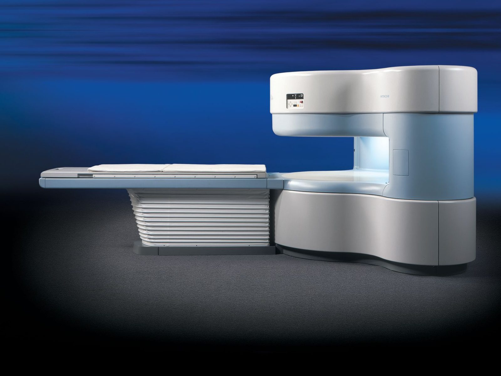 A Hitachi AIRIS Elite open MRI scanner, with the magnet above and below the patient table and the sides left open.